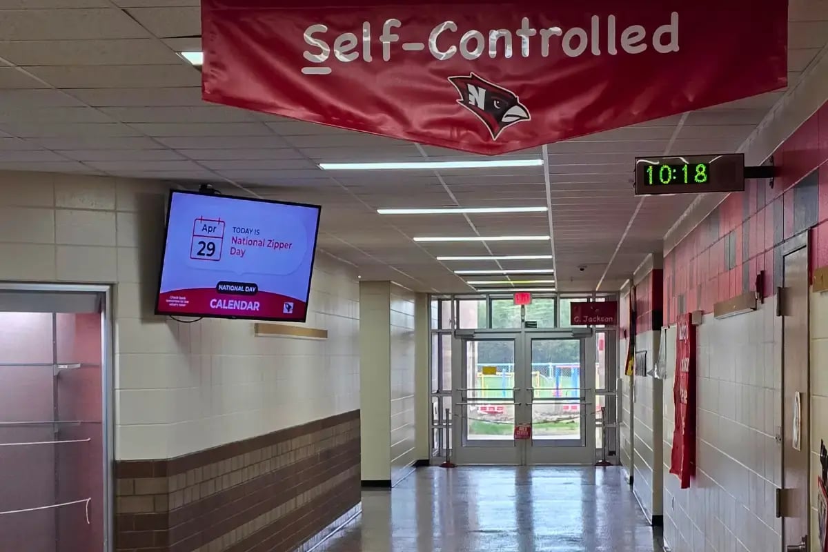 Necedah School interior hallway with digital signage display mounted on the wall