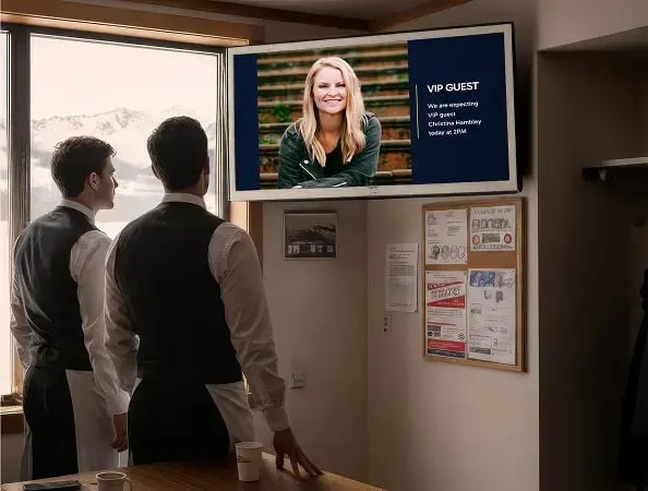 Staff communication hub with a digital display showing the VIP guest of the day for two chefs
