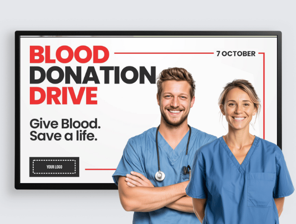 Two nurses standing in front of a display promoting a blood drive