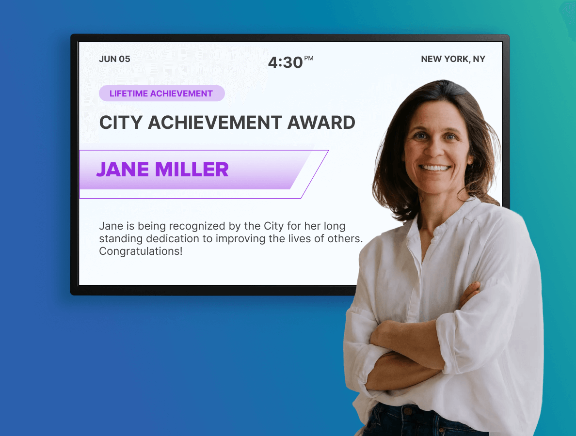 A female government worker standing in front of a digital display