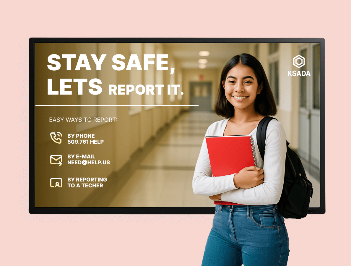 A female college student stands in front of a digital signage display for school safety