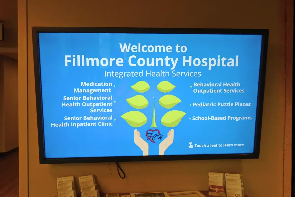 A large digital display signage on a wall for a hospital